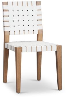 a white and brown chair sitting on top of a wooden table