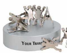 three metal figurines are on top of a silver stand with the words your travel