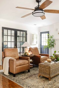 a living room filled with furniture and a ceiling fan in the middle of the room