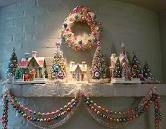 a mantle decorated with christmas decorations and wreaths