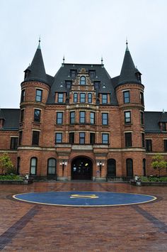 a large brick building with a clock on the front