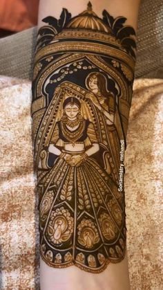 a woman's arm covered in hendik with an intricate design on it