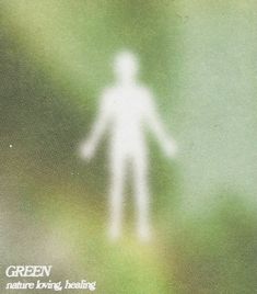 a blurry image of a person standing in the grass