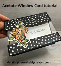 a hand holding an empty card box with polka dots and roses on the inside,