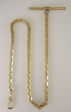 This is a long gold plated watch chain which measures 340mm in length from the T bar to the dog clip. The chain is made up of interlocking square links with milled detailing. The chain is in in 100% mint condition. The chain also comes with a vintage leather bow guard. Not shown. Gold Plated Watch, Pocket Watch Antique, Pocket Watch Chain, Dog Clip, Victorian Gold, Leather Bow, Choker Style, Pocket Watches, Watch Chain