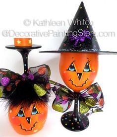 two wine glasses decorated with pumpkins and witches hats