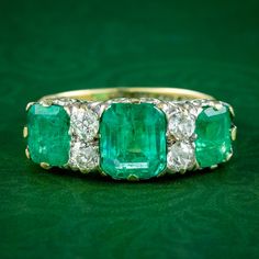 A magnificent antique Victorian carved half hoop ring adorned with three large step-cut emeralds and four old European cut diamonds which are all natural and detailed in the accompanying gem certification. The emeralds have a bright, vivid green hue and weigh approx. 1.47ct in the centre with 0.80ct stones on either side (3.07ct total). The diamonds complement them beautifully and have SI1 clarity - I/J colour and total approx. 0.44ct. Emerald is the birthstone of May. The Romans considered it t Antique Emerald Engagement Ring, Antique Emerald Ring, Gold Gallery, Sacred Stones, Emerald Diamond Ring, Victorian Rings, Step Cut, Emerald Engagement, European Cut Diamonds