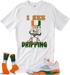 Custom Shirts to match the Jordan 5 Hurricanes Sizing Chart is available Since all items are made to order, all sales are final. Please use the sizing chart for assistance with selecting the correct size. Since all items are custom and made to order we do not accept return or do exchanges. This shirt is available in kids and adults We try to ship all orders out ASAP But There is a 1-3 business day handling time. Washing instructions: 1. Cold/warm water 2. Turn item inside out 3. Do not bleach or use oxy clean detergent. 4. Hang and Air dry recommended We also do special request for any hard to match sneaker you may have. Message us Casual Fitted T-shirt For Game Day, Casual White Shirt With Team Name, Casual College Shirt With Sublimation Print, White Team Spirit Shirt For Streetwear, Casual Team Name Shirt For Streetwear, Casual Streetwear Shirt With Team Name, Casual Game Day Shirt With Sublimation Print, Casual Fitted T-shirt With Team Name, Clean Detergent