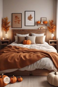 a bedroom with pumpkins on the floor and pictures above it