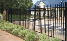 a fenced in parking lot next to a building