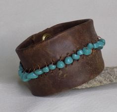 This wide leather bracelet is approximately 2 inches by 8.5 inches with a double snap closure. It has a line of  stone, turquoise beads woven with copper wire connecting the two halves of the leather bracelet. This bracelet can be worn everyday and is very durable thick leather, but is still soft. Rustic Turquoise Leather Bracelet, Handmade Leather Turquoise Bracelets, Handmade Turquoise Leather Cuff Bracelet, Handmade Leather Bracelet In Turquoise, Handmade Turquoise Leather Bracelet, Leather Bible Cover, Leather Bible, Large Bracelet, Brown Leather Bracelet