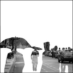 black and white photograph of people walking down the street with cars parked on both sides