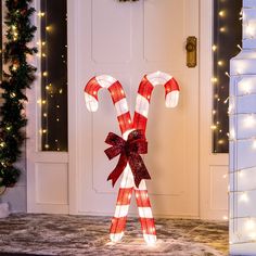 lighted candy canes in front of a door