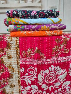 a stack of colorful fabrics sitting on top of each other