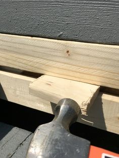 a hammer is next to some wood planks