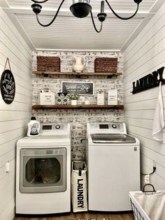 a white washer and dryer sitting next to each other in a laundry room