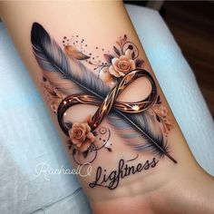 a tattoo on the wrist that says lightness with flowers and a feather in it