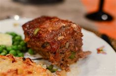 a white plate topped with meat and veggies