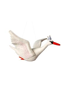 a white bird flying through the air with a red beak and long legs on it's body