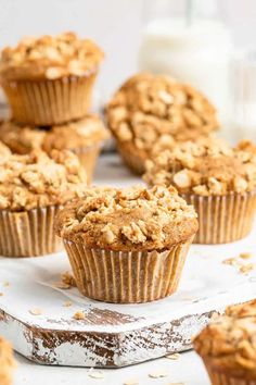 several muffins sitting on top of a white plate next to a glass of milk