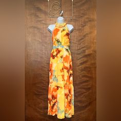 Gorgeous Yellow Abstract Floral Chiffon Maxi Dress From Tahari: Arthur S. Levine In Women's Size 8. Measurements: 34" Bust | 30" Waist | 40" Hips | 16" Bodice Length | 58" Length. Women's Dress Is A Bright Yellow Color With A Muted Abstract Floral Pattern. Material Is A Flowy Polyester Chiffon. Flattering Halter Neckline -- Has Straps In The Back That Tie. Sleeveless. Defined Waist With Waistband. Lightly Gathered Above & Below The Waist. Long Maxi Length. Ruffle Flounce At The Hem. Lightly Gath Fall Maxi Dress, Fall Maxi, Floral Chiffon Maxi Dress, Maxi Dress Sleeveless, Defined Waist, Maxi Dresses Fall, Yellow Abstract, Chiffon Maxi, Halter Maxi Dresses