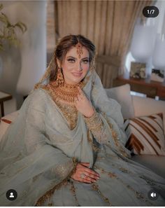 a woman in a bridal outfit posing for a photo