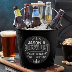 an ice bucket filled with beer bottles next to a bottle opener