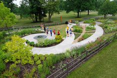 an aerial view of people walking through a garden