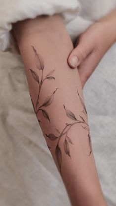 a woman's leg with leaves on it