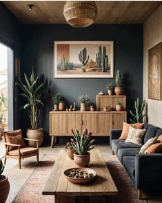 a living room filled with furniture and potted plants on top of a wooden table