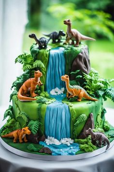 a cake decorated with different types of dinosaurs