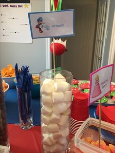 a table topped with lots of marshmallows and other dessert items on top of it