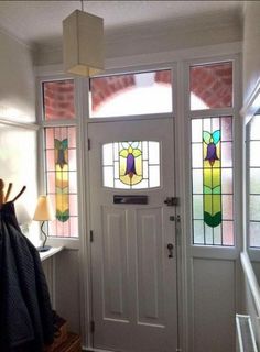 a white door with stained glass windows in it