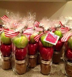 an image of homemade caramel sauce in jars with apples and candy canes on top