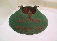 a green sign that says seasons greetings