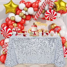 a table topped with balloons and candy canes