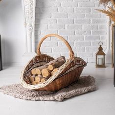 a basket filled with logs sitting on top of a rug