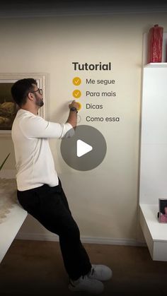 a man writing on a white board in front of a wall with the words learn spanish