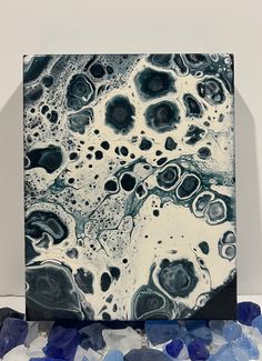 a black and white abstract painting with lots of blue rocks