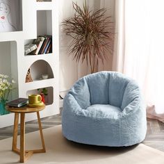 a living room filled with furniture and a potted plant