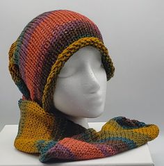 a mannequin wearing a multicolored knitted hat and scarf