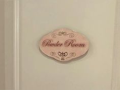 a pink sign that says gender room on the side of a white door with black lettering