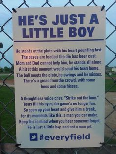 a sign posted on a fence that says he's just a little boy