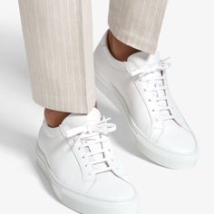 A versatile and
 classic white sneaker that brings casual levity to any look, these calf
 leather kicks feature full light brown leather lining, flat waxed laces, and
 rubber sole. Grey Runner, Light Brown Leather, Shoe Tree, Leather Conditioner, Classic White, Fashion Advice, Cleaning Clothes, Cow Leather, White Sneaker