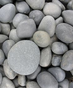 rocks and gravel are arranged together on the ground