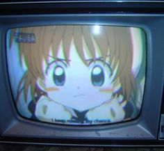 an old television with anime character on it's screen and the tv is turned off