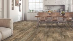 a kitchen and dining room with wood flooring in an open concept style living area