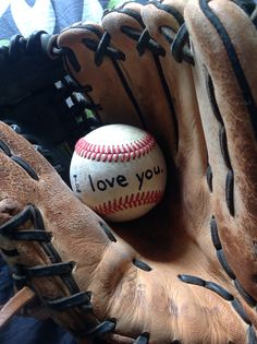 a baseball in a catchers mitt with the words i love you written on it