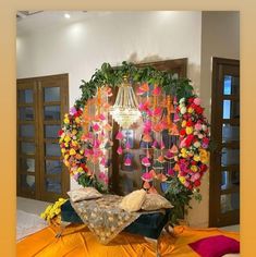 a bed covered in flowers and hanging from a chandelier