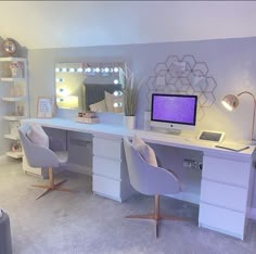 a white desk topped with a computer monitor next to a mirror and chair in a room